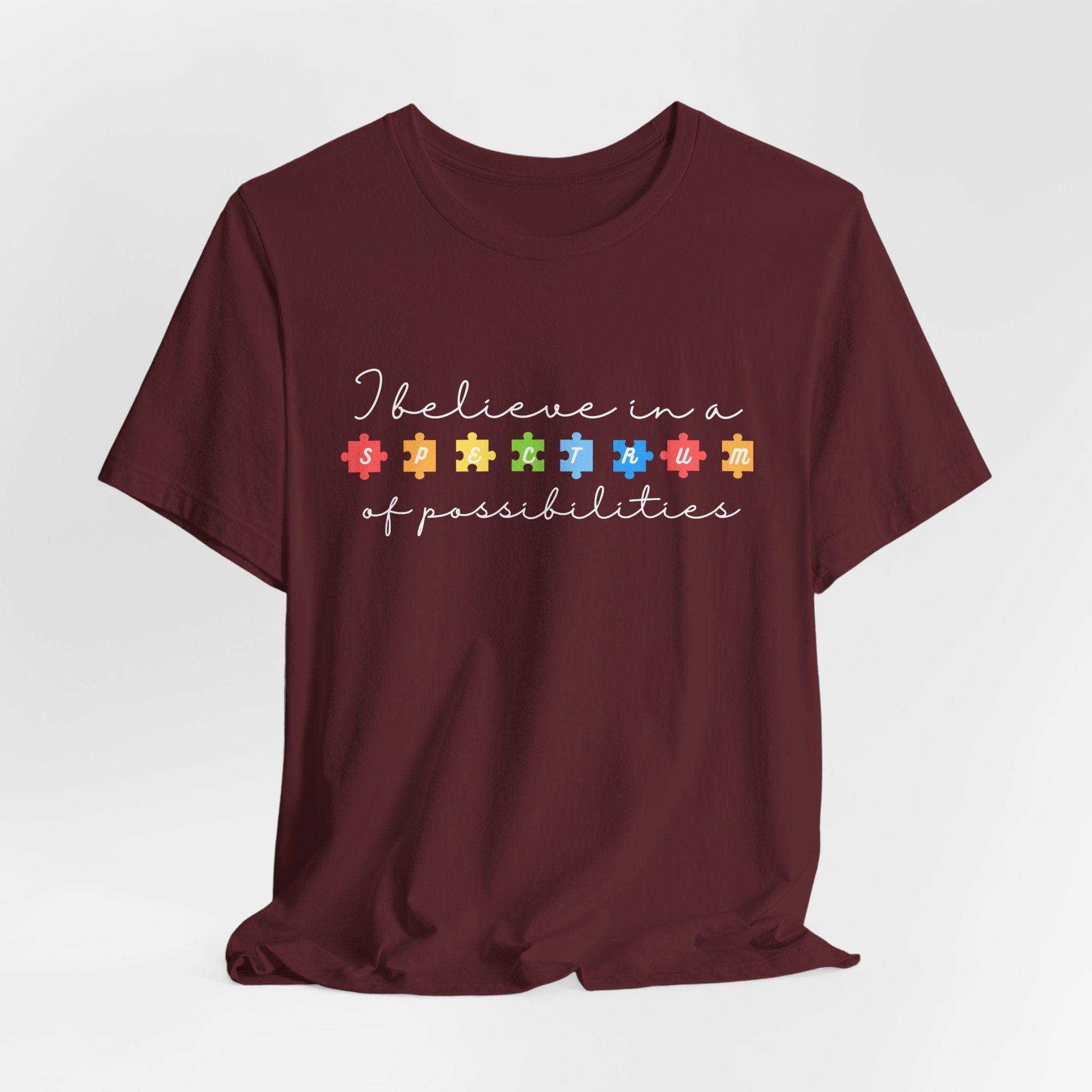 I Believe in a Spectrum of Possibilities T-Shirt | Autism Awareness puzzle pieces | White writing