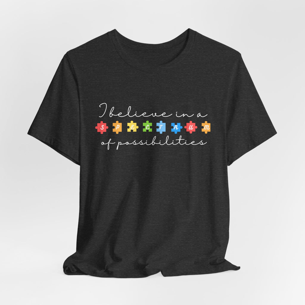 I Believe in a Spectrum of Possibilities T-Shirt | Autism Awareness puzzle pieces | White writing