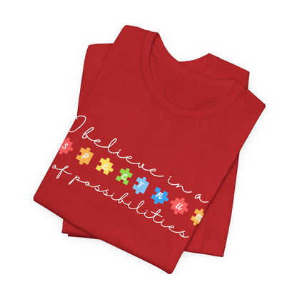 I Believe in a Spectrum of Possibilities T-Shirt | Autism Awareness puzzle pieces | White writing