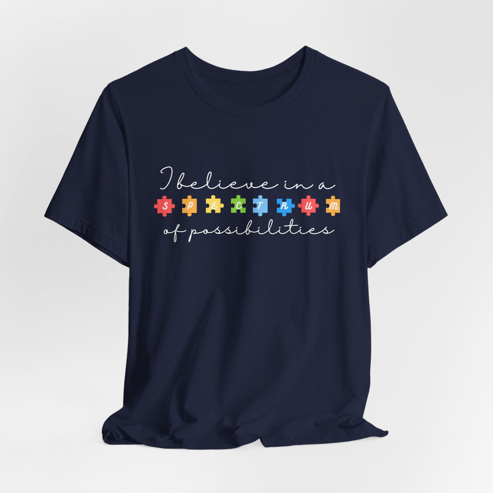 I Believe in a Spectrum of Possibilities T-Shirt | Autism Awareness puzzle pieces | White writing