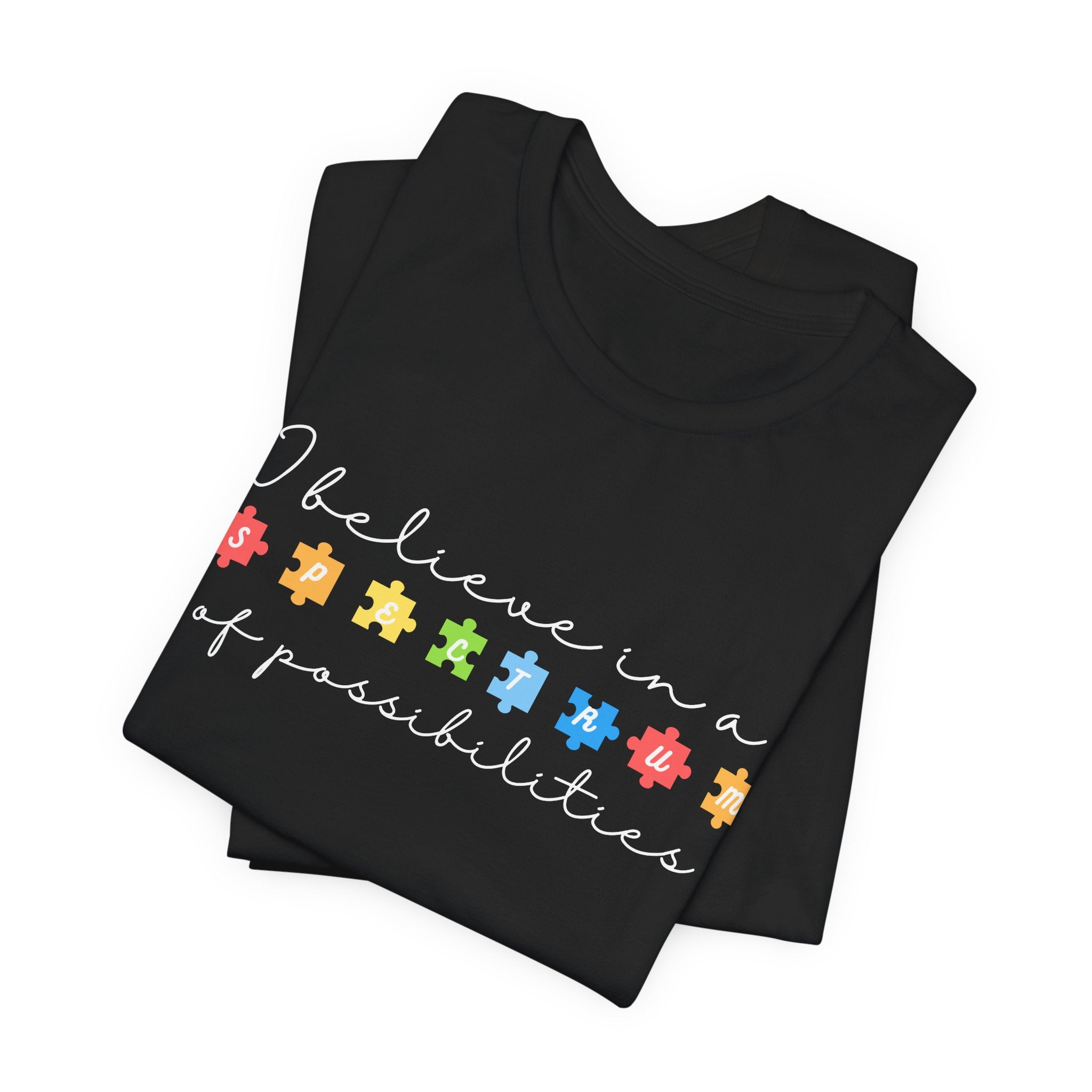 I Believe in a Spectrum of Possibilities T-Shirt | Autism Awareness puzzle pieces | White writing