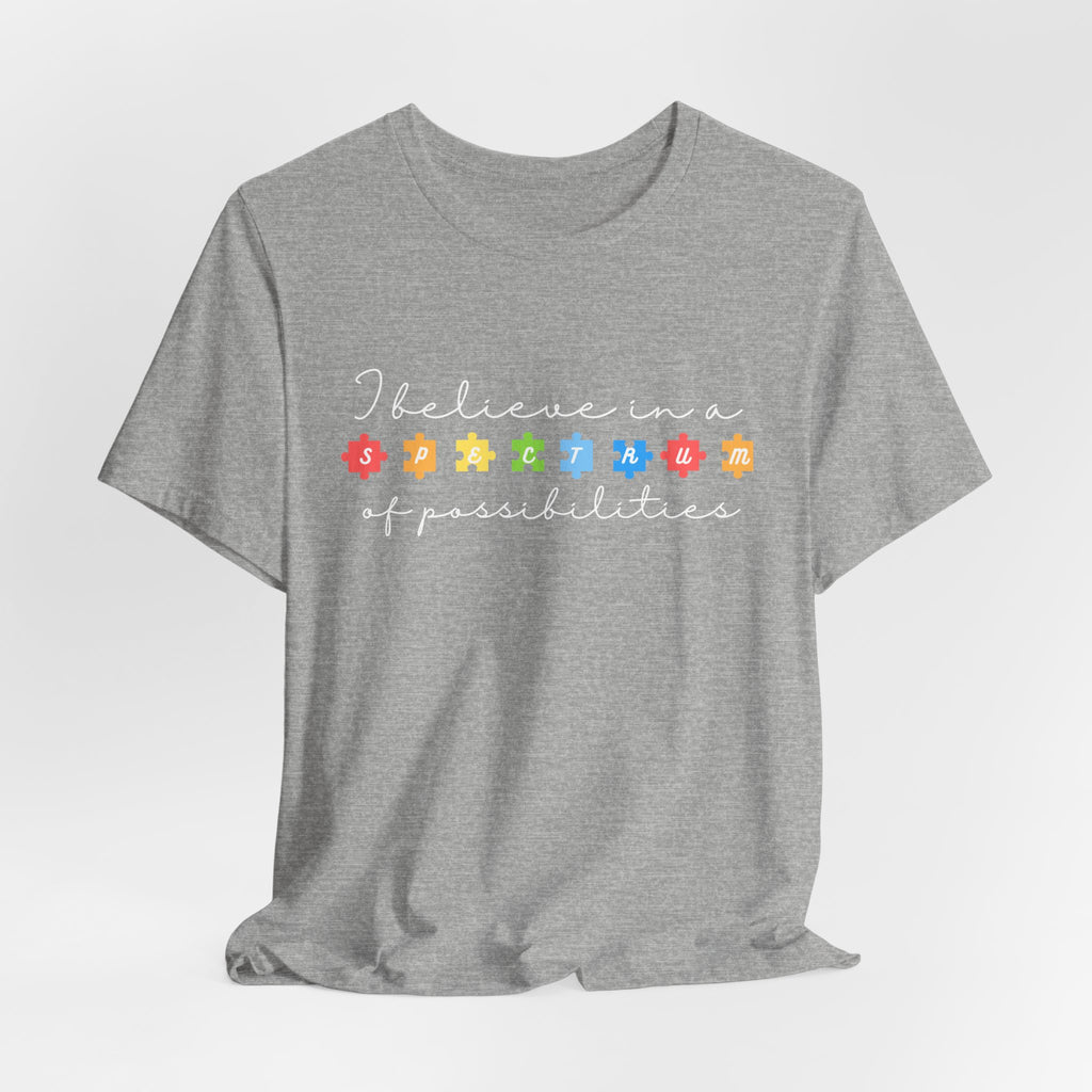 I Believe in a Spectrum of Possibilities T-Shirt | Autism Awareness puzzle pieces | White writing