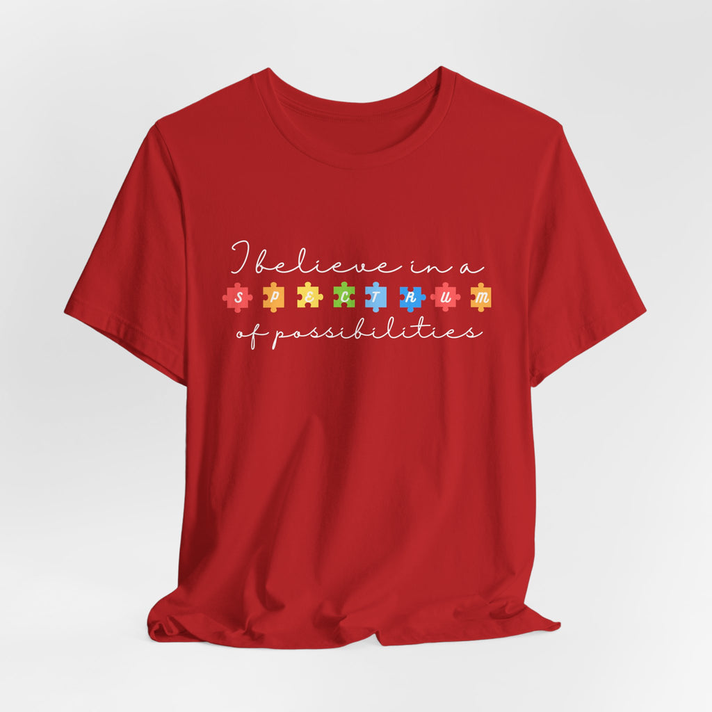 I Believe in a Spectrum of Possibilities T-Shirt | Autism Awareness puzzle pieces | White writing
