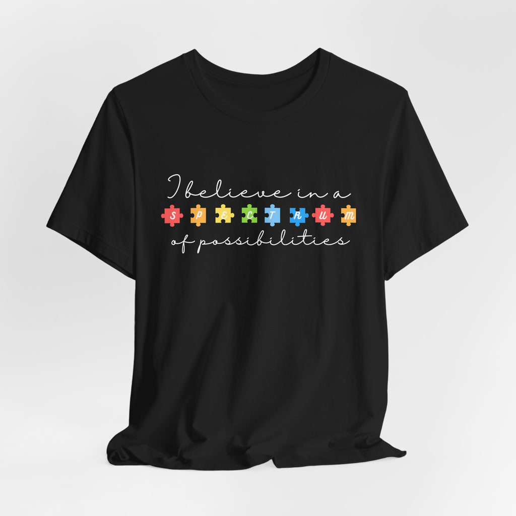 I Believe in a Spectrum of Possibilities T-Shirt | Autism Awareness puzzle pieces | White writing