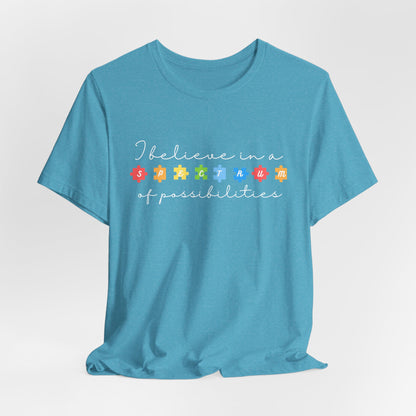 I Believe in a Spectrum of Possibilities T-Shirt | Autism Awareness puzzle pieces | White writing