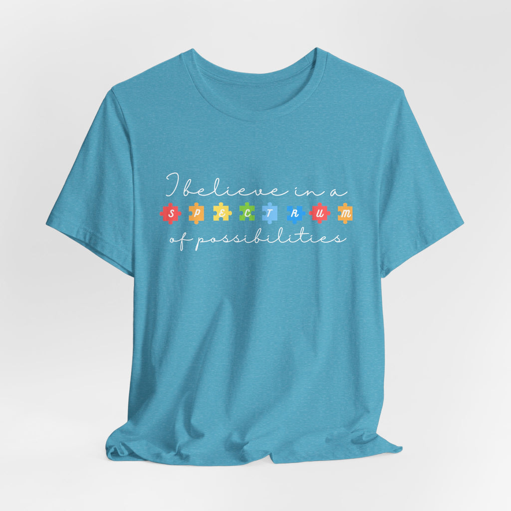 I Believe in a Spectrum of Possibilities T-Shirt | Autism Awareness puzzle pieces | White writing