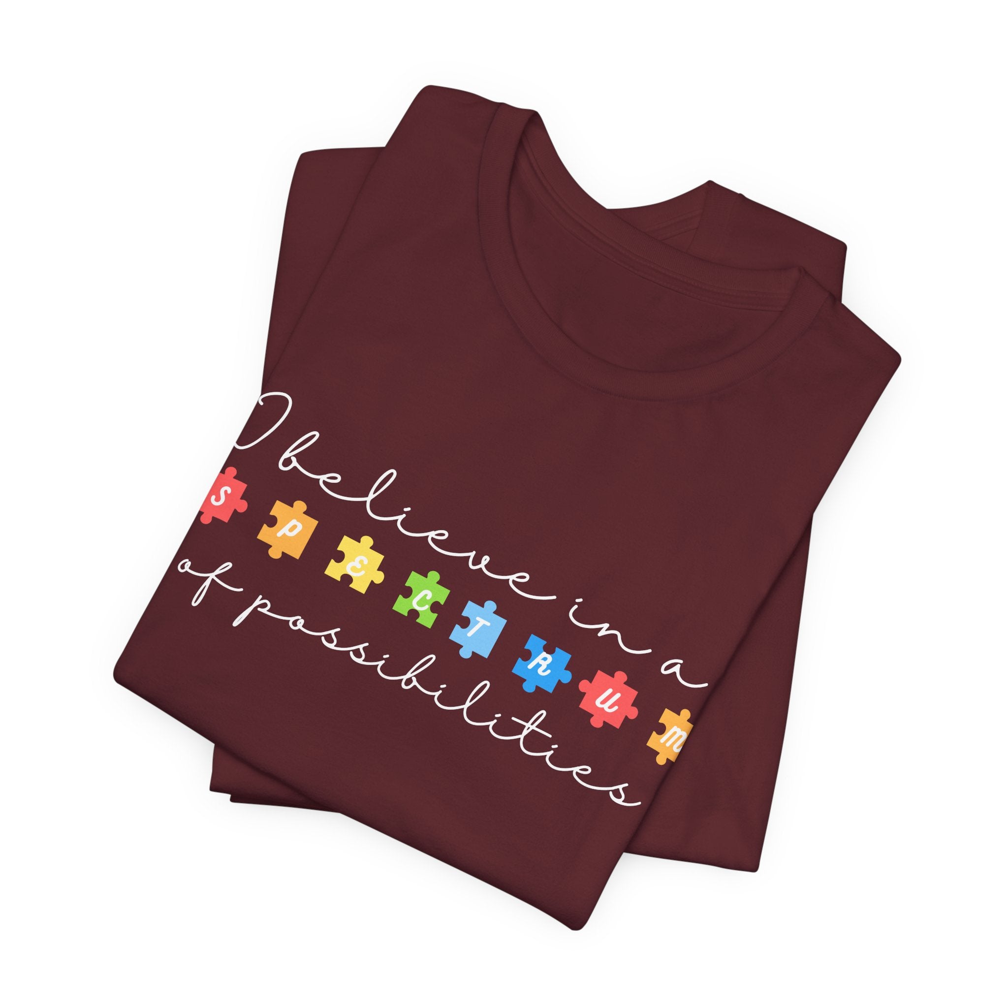 I Believe in a Spectrum of Possibilities T-Shirt | Autism Awareness puzzle pieces | White writing