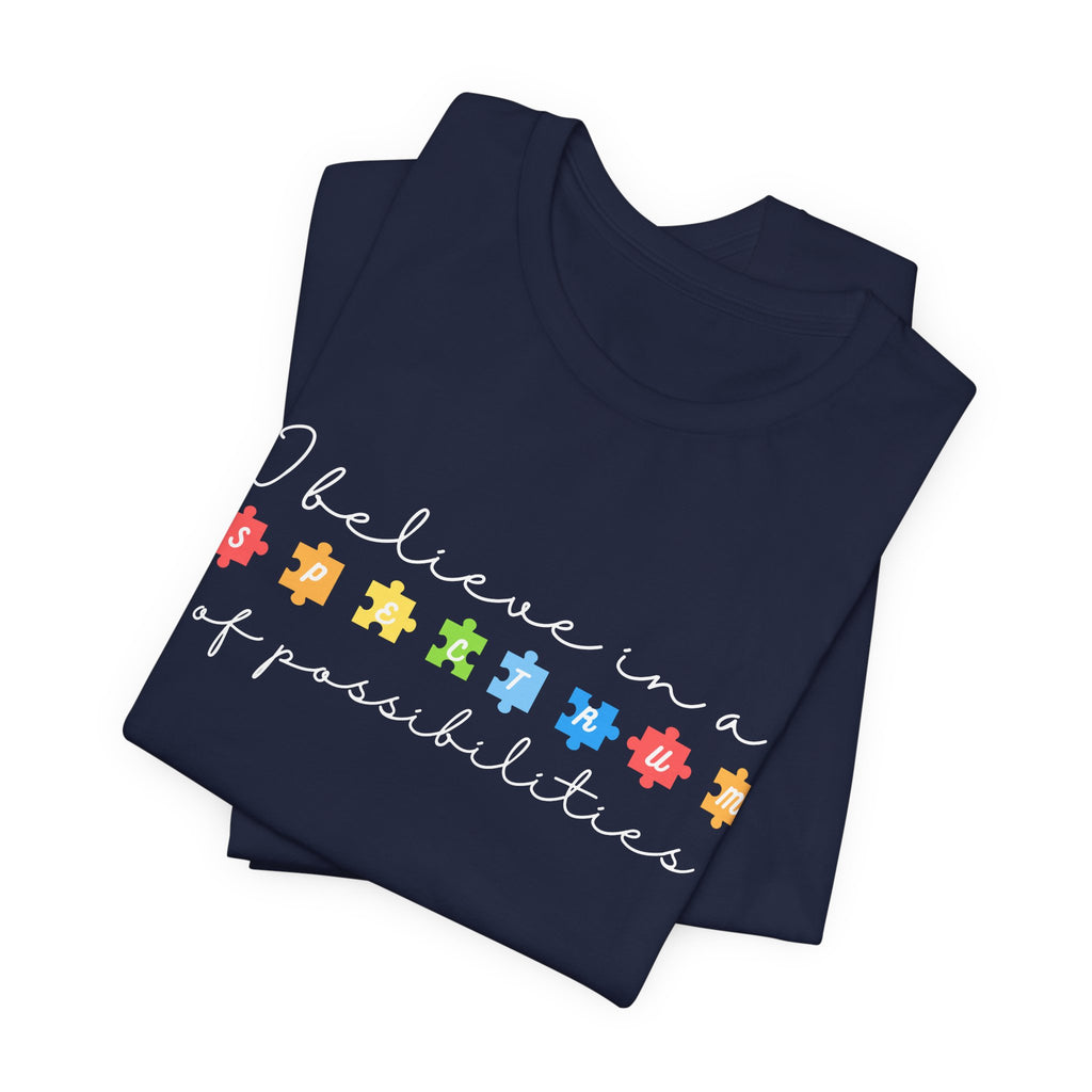 I Believe in a Spectrum of Possibilities T-Shirt | Autism Awareness puzzle pieces | White writing