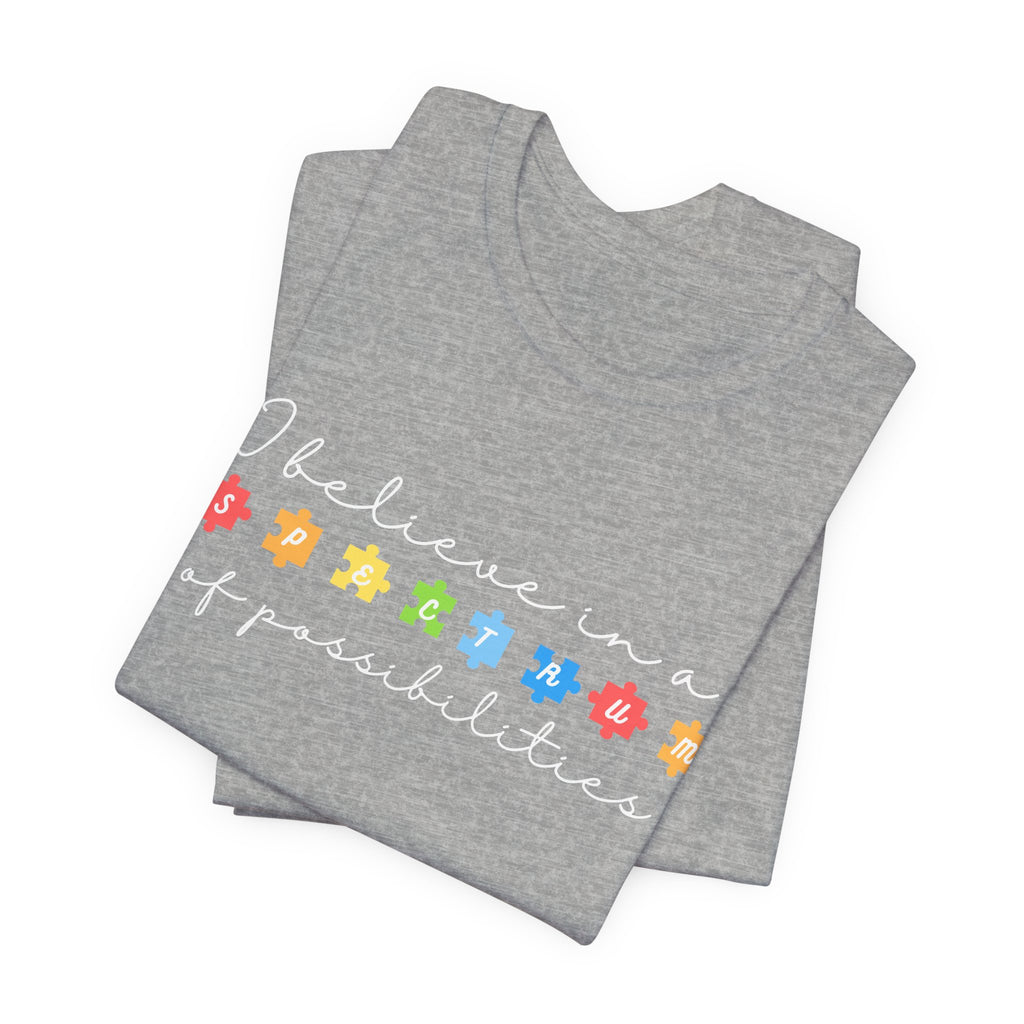 I Believe in a Spectrum of Possibilities T-Shirt | Autism Awareness puzzle pieces | White writing
